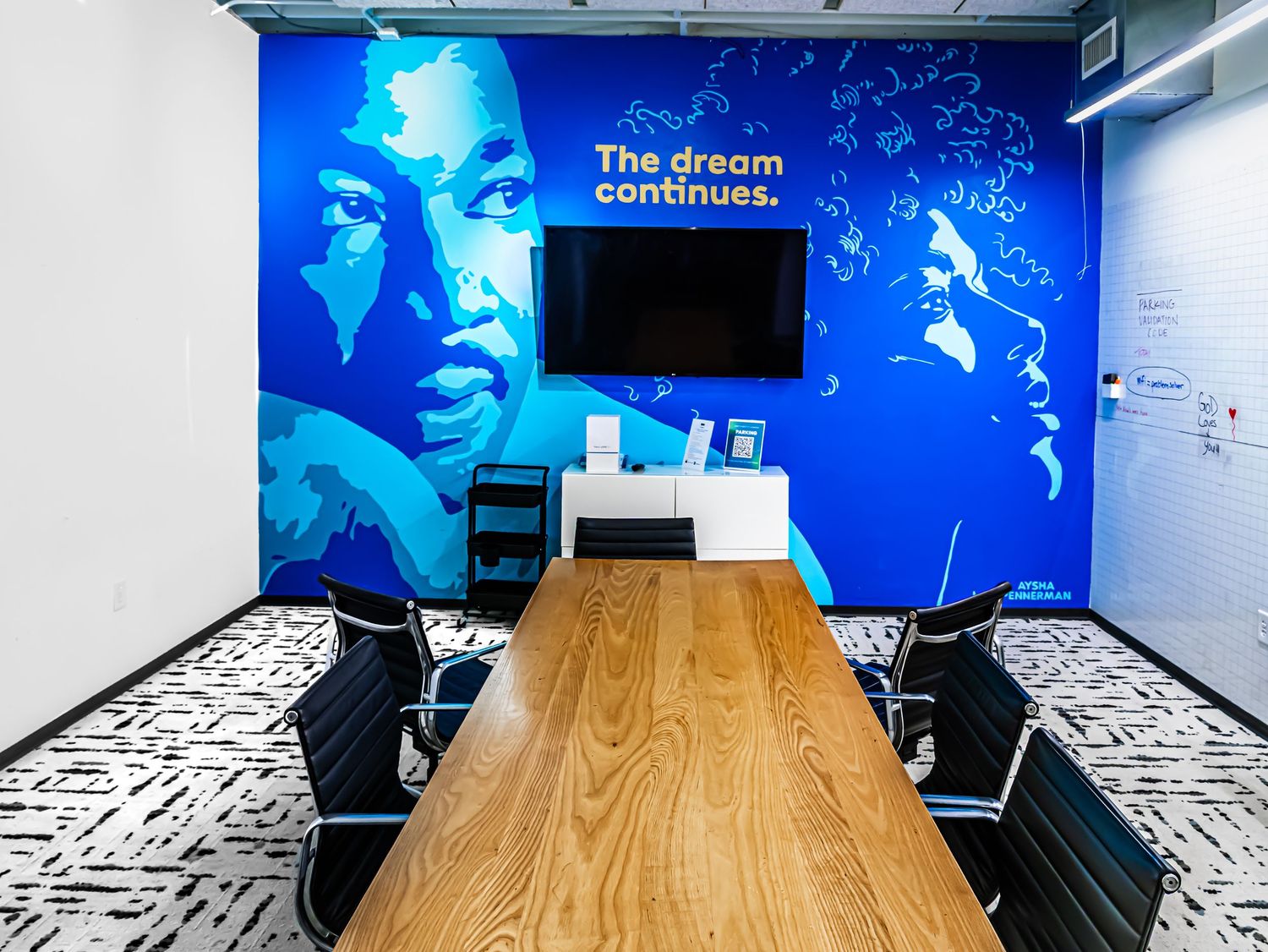 Commercial architectural photography of a modern corporate boardroom featuring a large blue Martin Luther King Jr. mural in Atlanta GA.