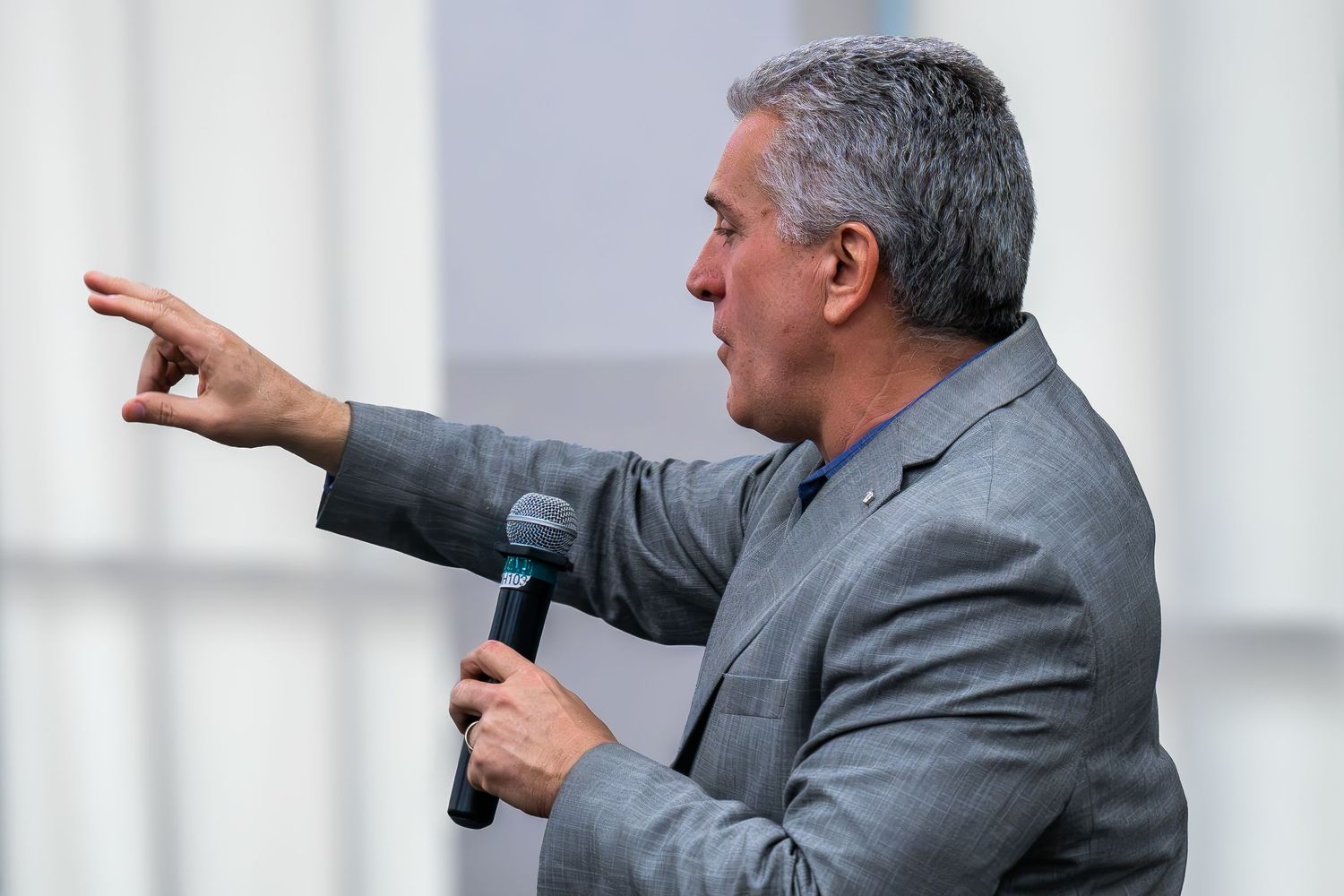 Dynamic corporate event photography of a business leader presenting on stage.