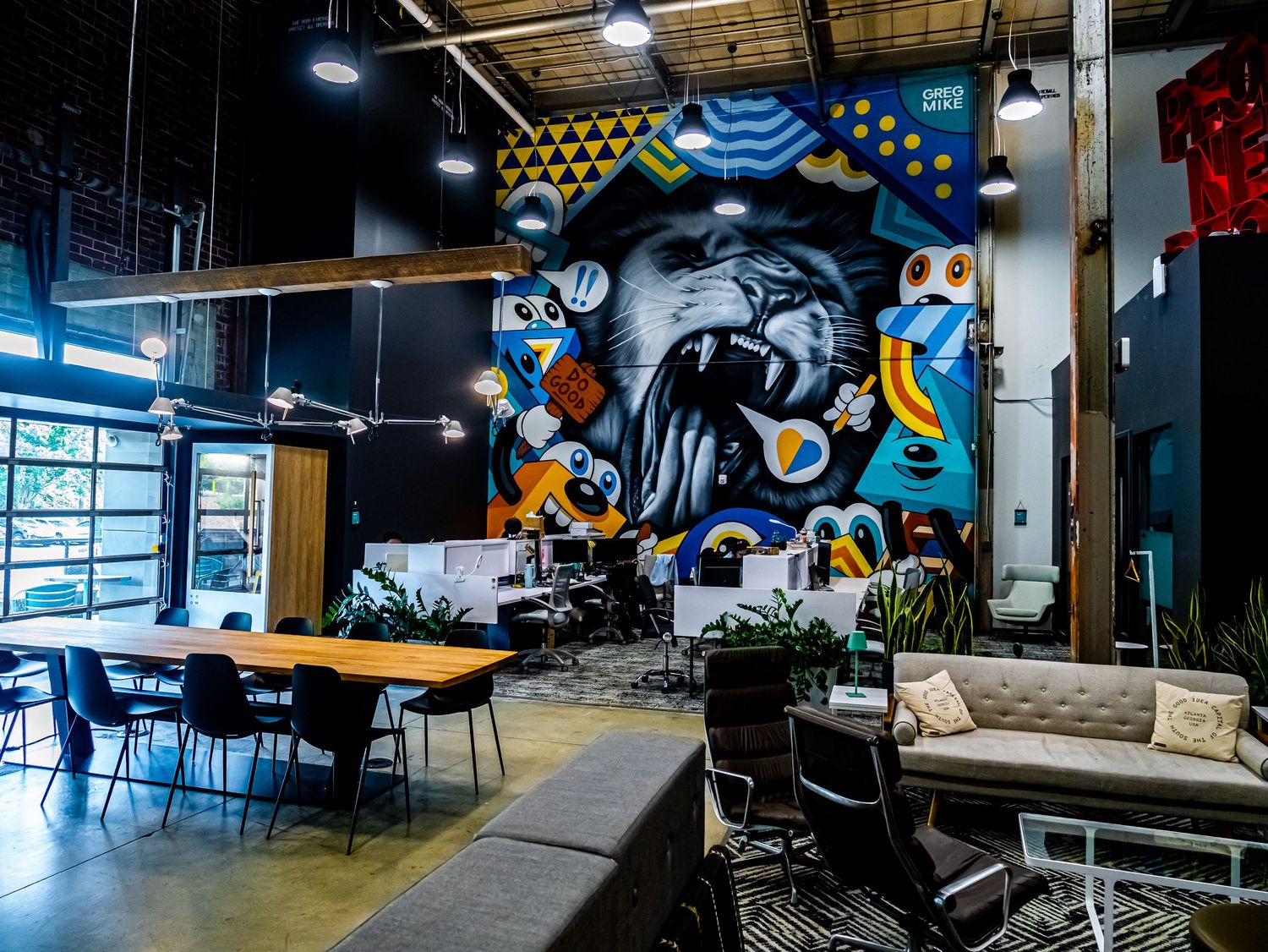 Architectural interior photography of a modern commercial office space and lounge area featuring a large wall mural.