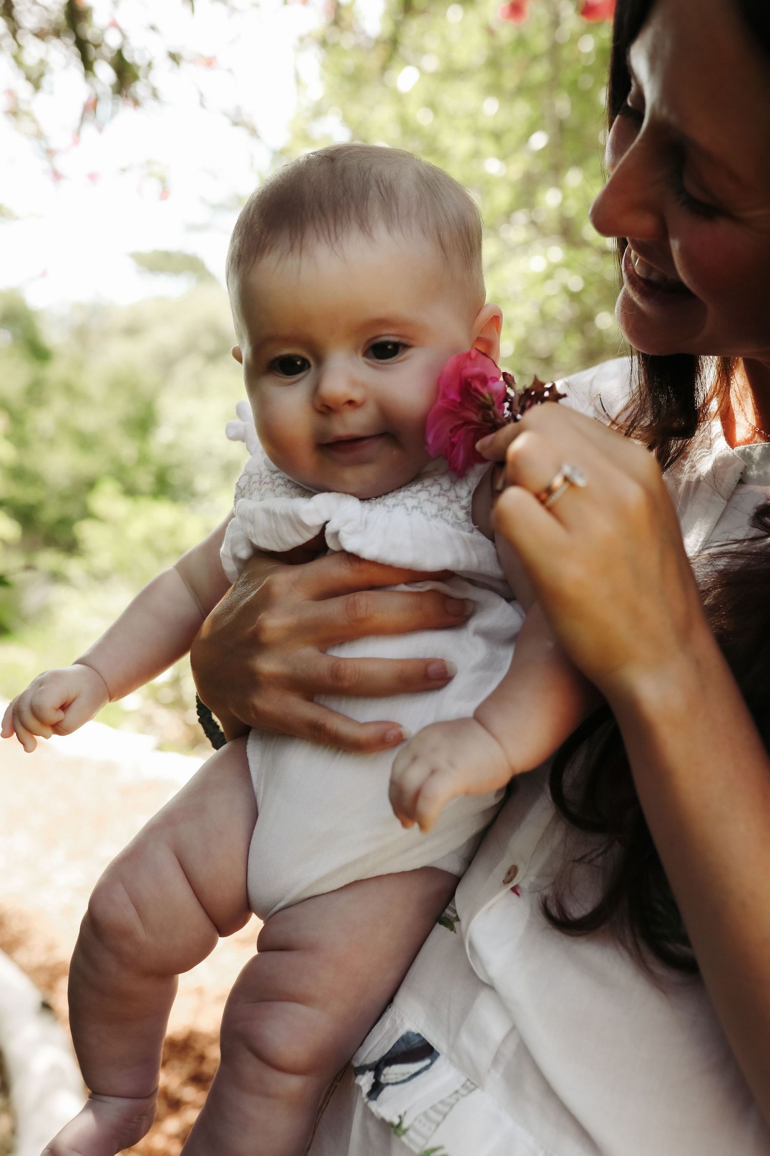 Mother holding baby with flower in garden setting, Sydney family photography