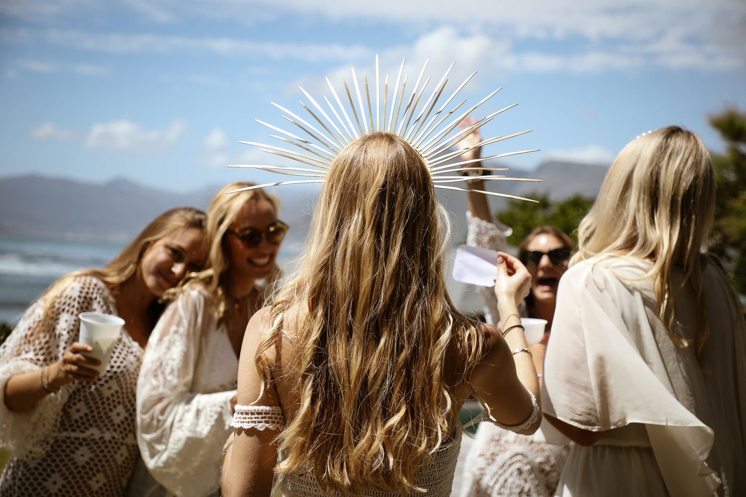 Woman with sun flare through hair at outdoor coastal bachelorette photography session, Sydney