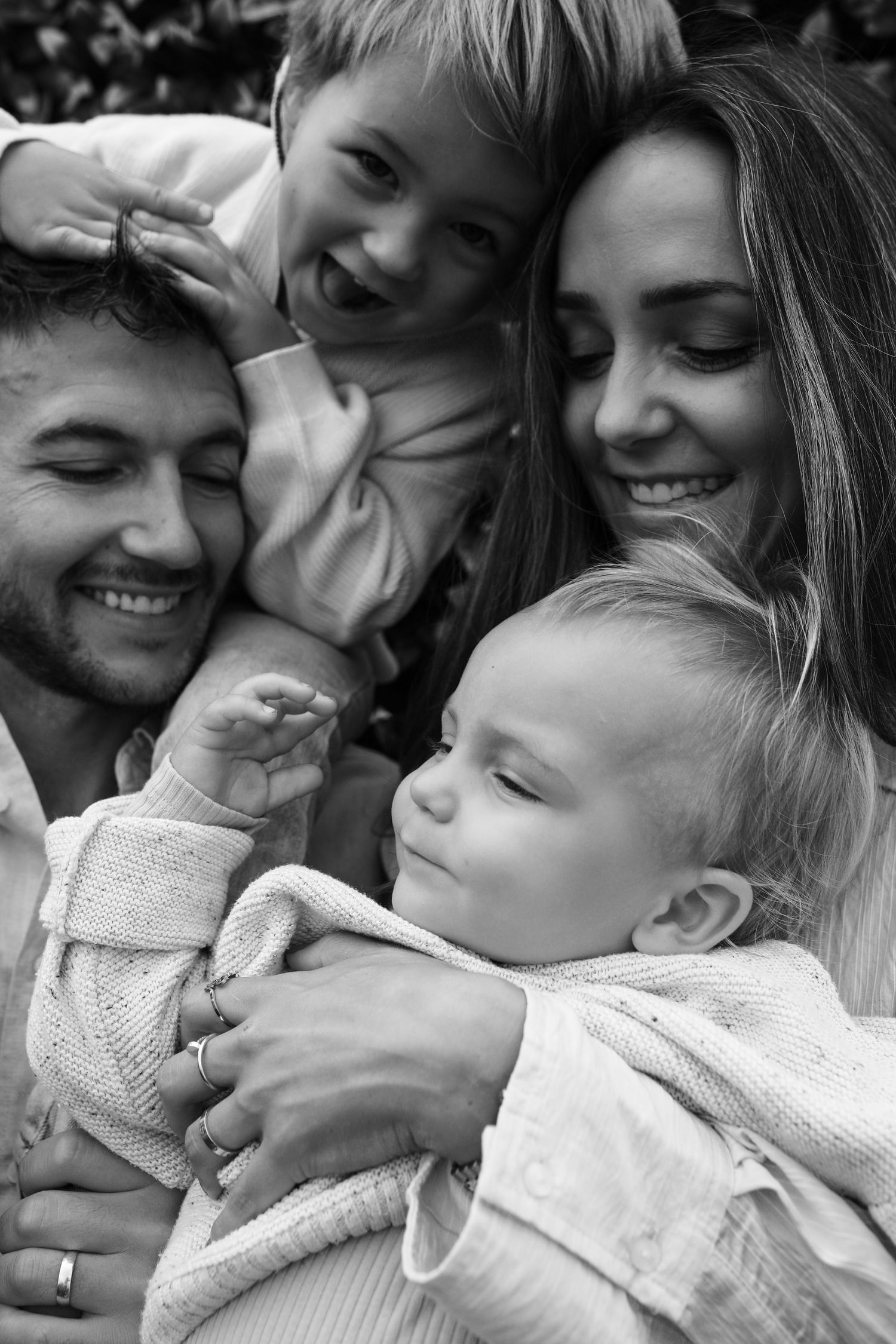 Black and white portrait of parents and young children laughing together, Sydney family photography