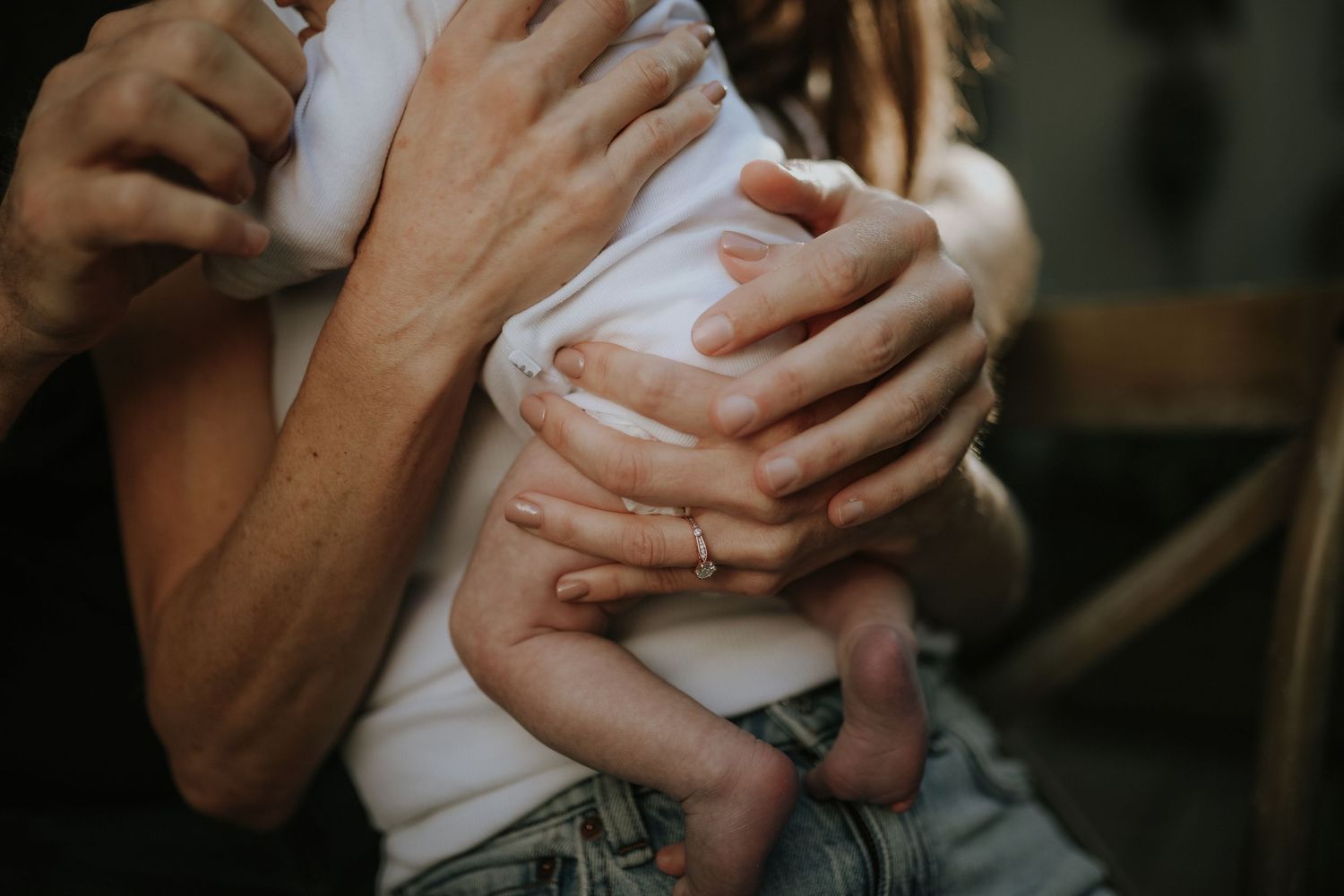Close-up of parent's hands cradling baby, Sydney family photography