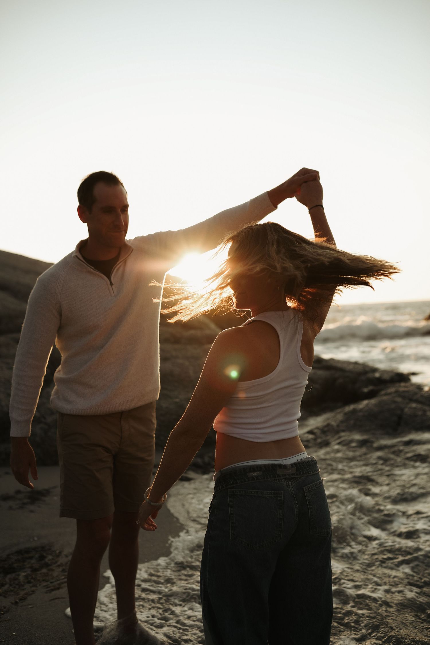 Pregnant Couple dancing together on the beach at sunset, Sydney lifestyle photography