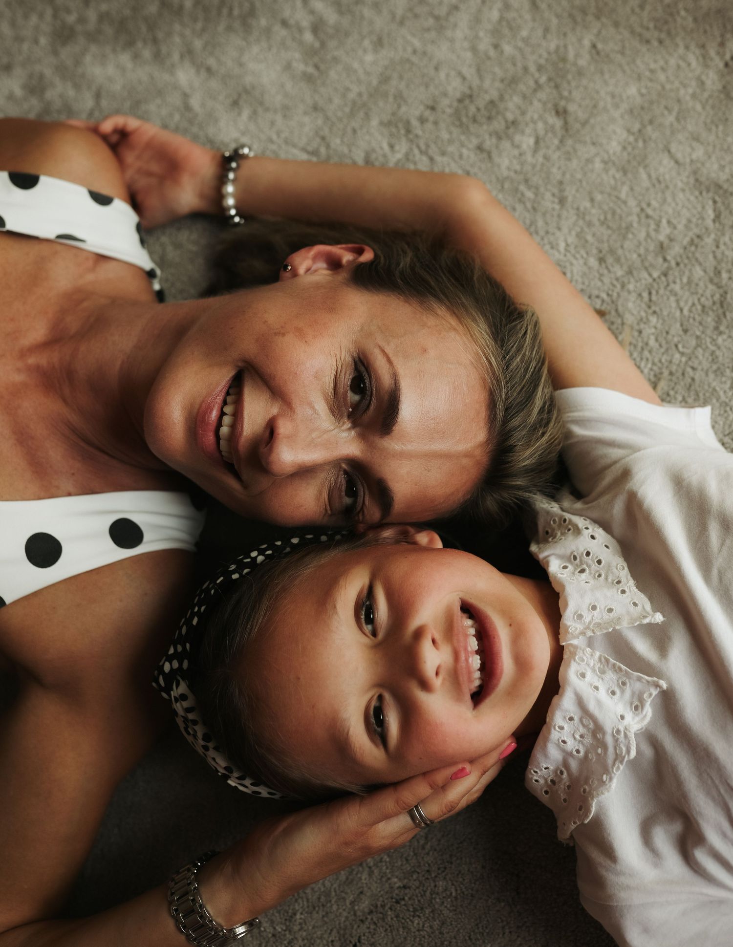 Mother and daughter lying down together laughing, Sydney family photography session