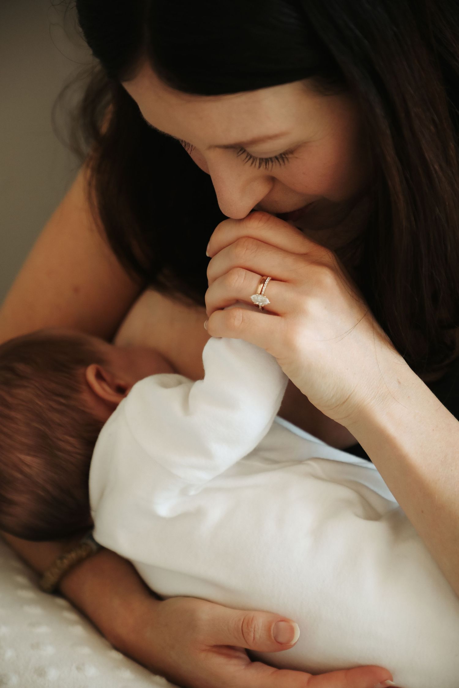 Mother kissing newborn baby's hand, Sydney newborn photography