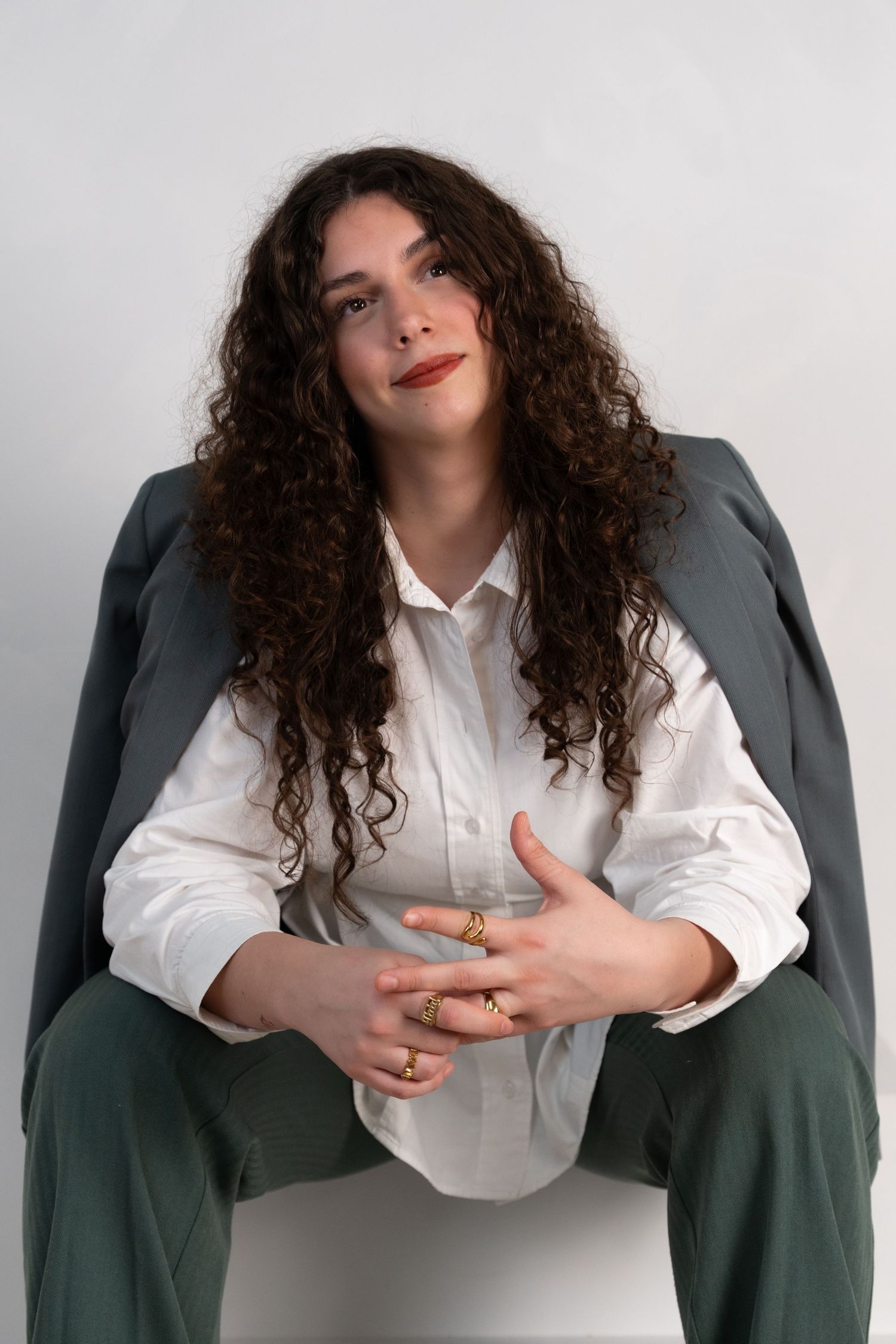 Personal branding portrait of a woman in a tailored blazer and gold rings, by Anya MacLaren Photography