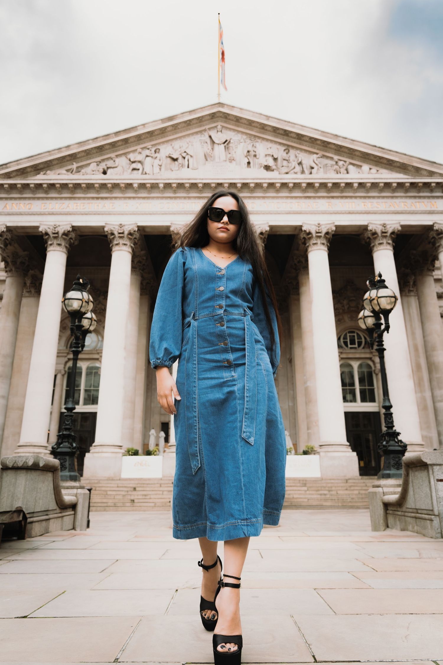 Fashion portrait of a woman in a denim dress in front of bank of england London building, by Anya MacLaren Photography