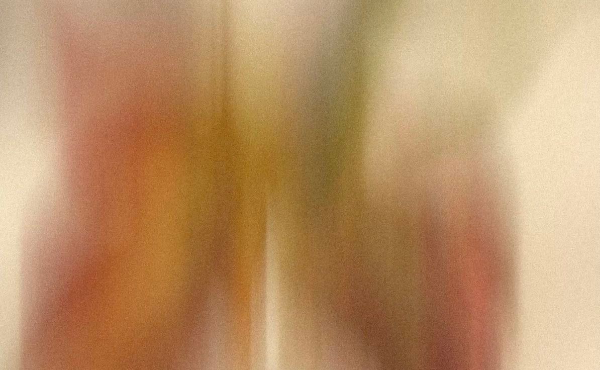 Abstract blurred artwork featuring warm red, orange, and olive green tones with soft gradient transitions.