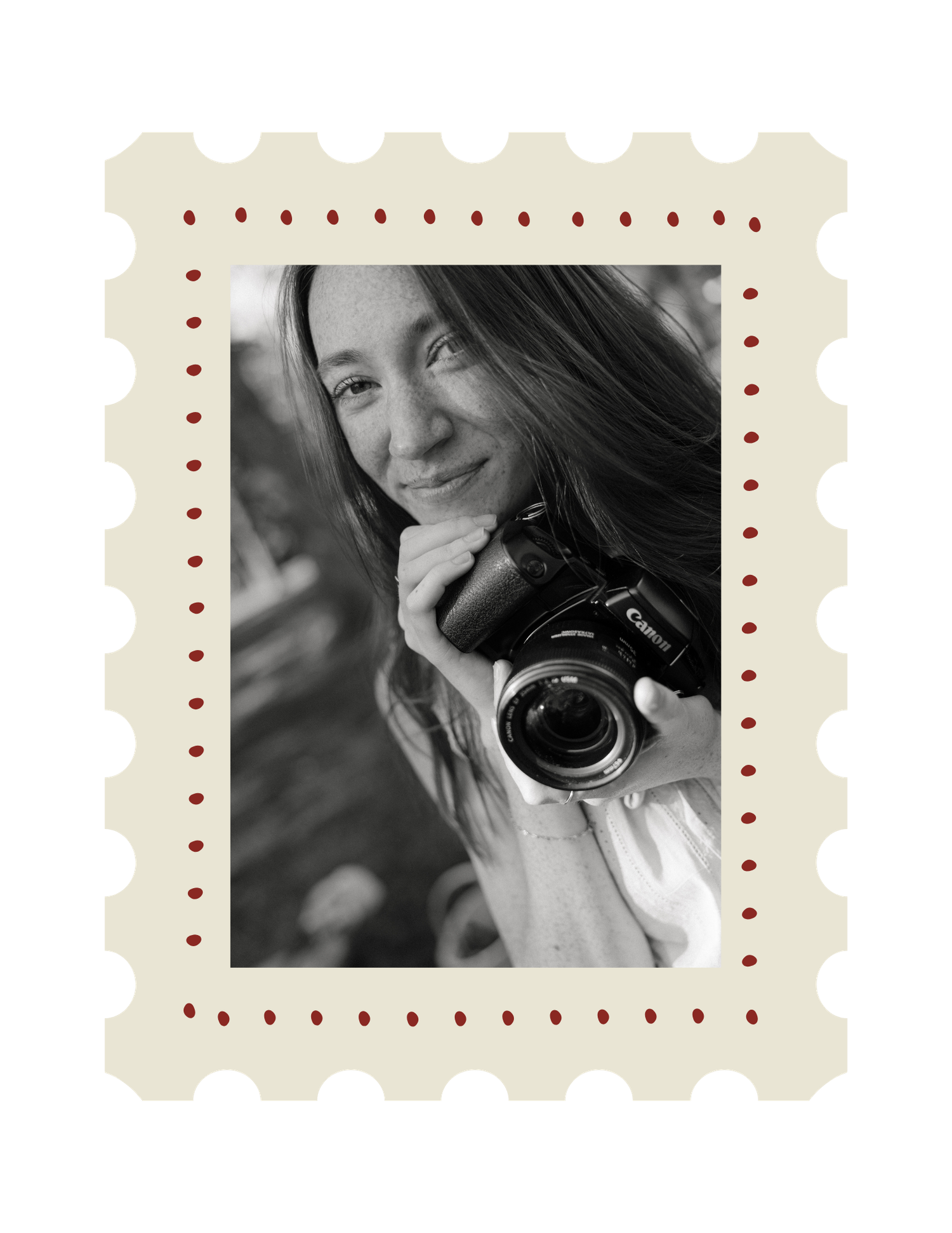 Black and white photo of a smiling woman holding a Canon camera, displayed in a decorative stamp-style frame.