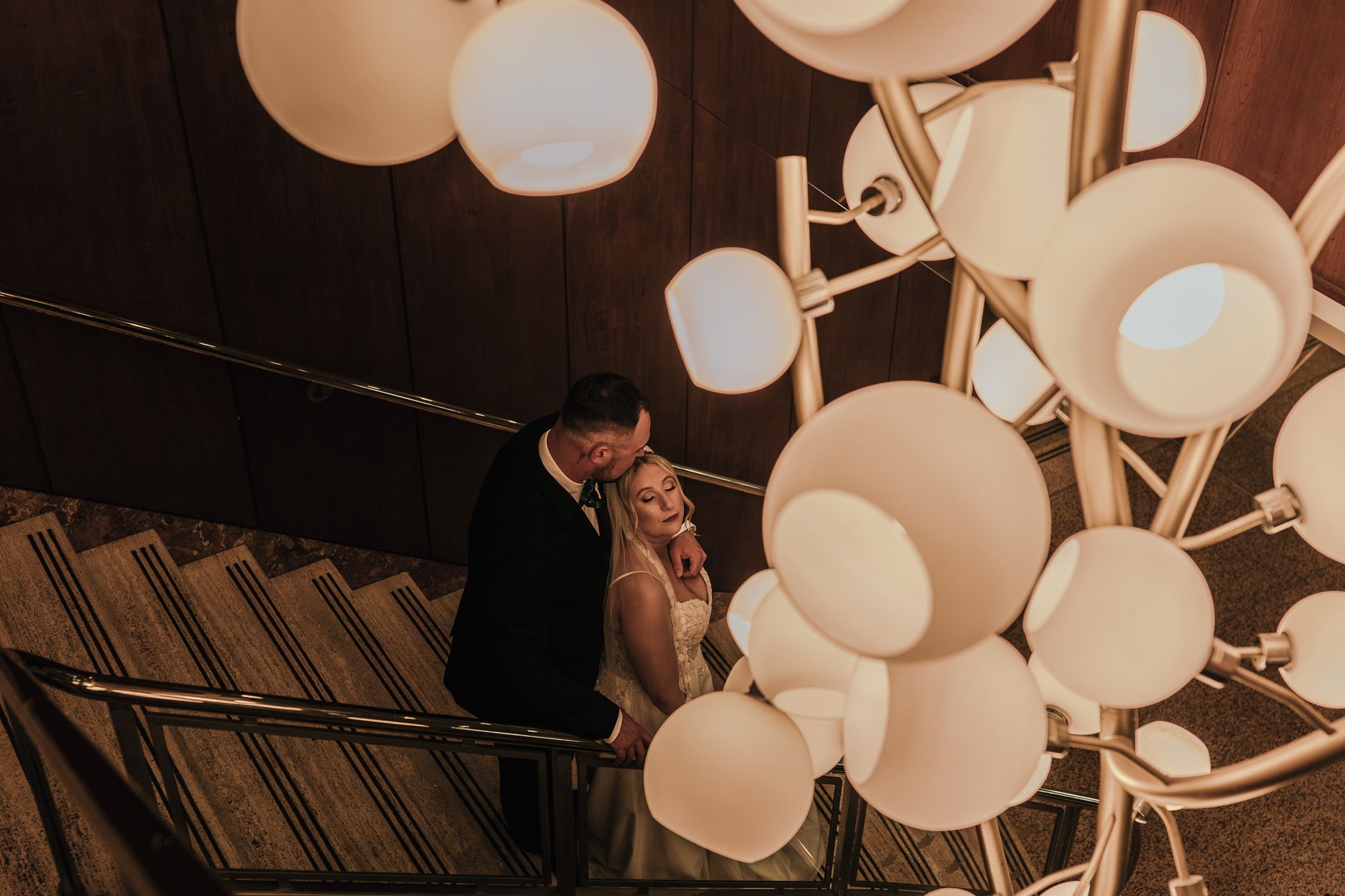 Destination wedding couple embracing in golden light