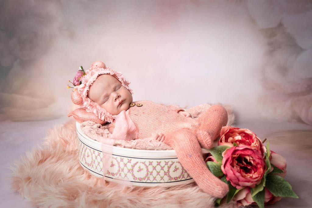 A collection of pink and peach colored floral arrangements with roses and decorative elements in a romantic vintage style.