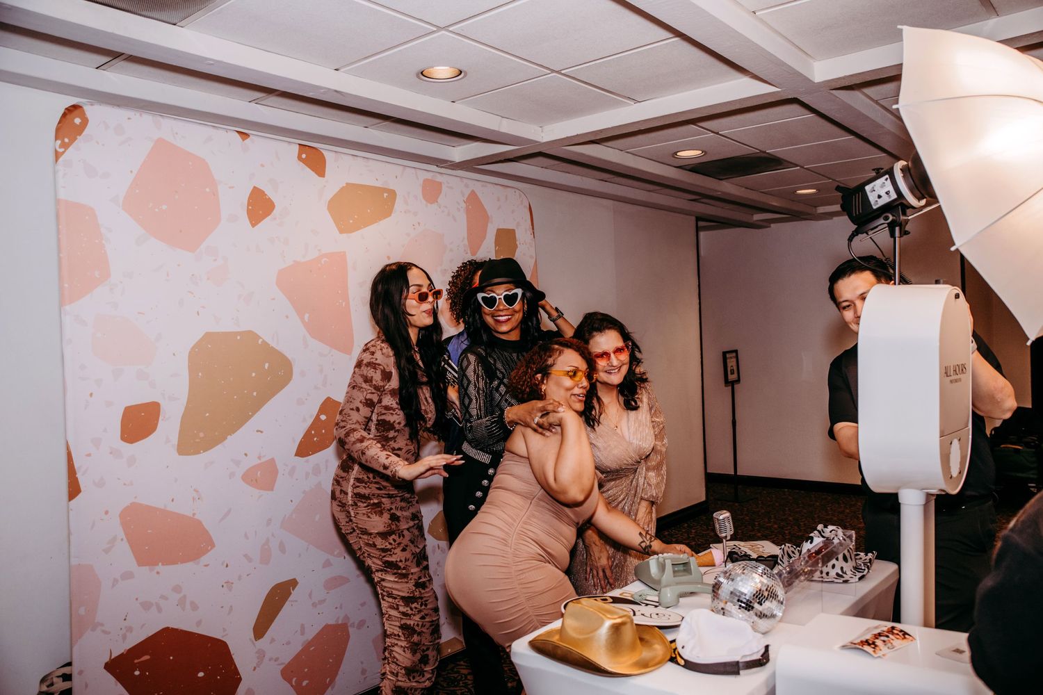 Friends enjoy the complimentary photo booth during the wedding reception.