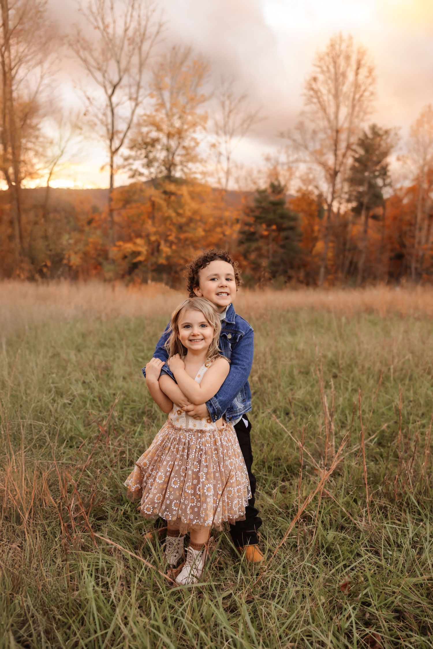 Siblings hugging during outdoor natural light family session Iron Station NC