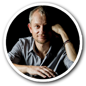 LinkedIn Headshot of Patrick Kirst cheek resting on hand black backdrop