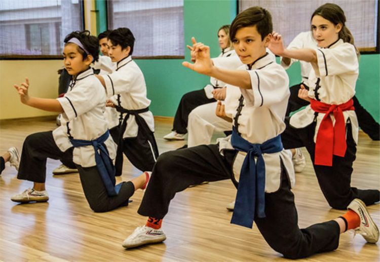 Student portrait several young children wearing gi practicing pose Zen Wellness class