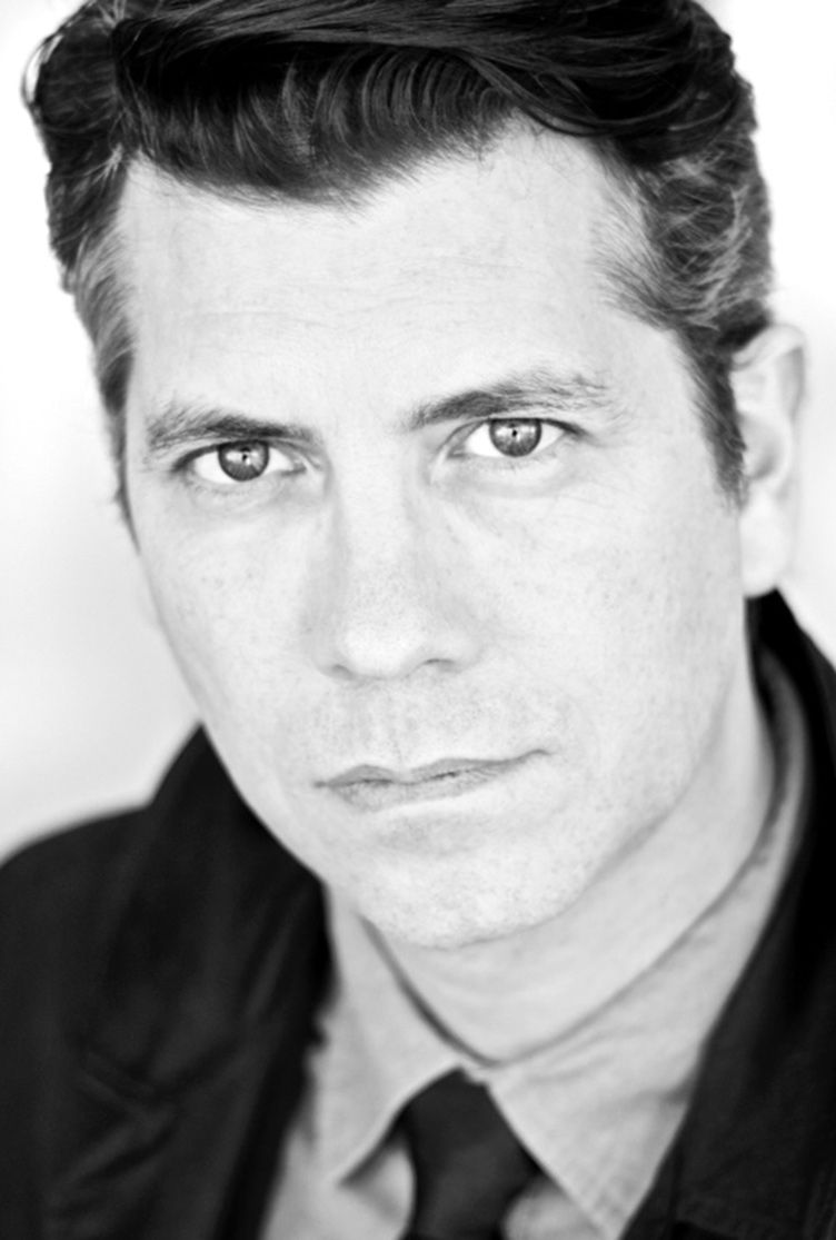 Business headshot black and white featuring Derek Maryanovich closeup wearing suit and tie