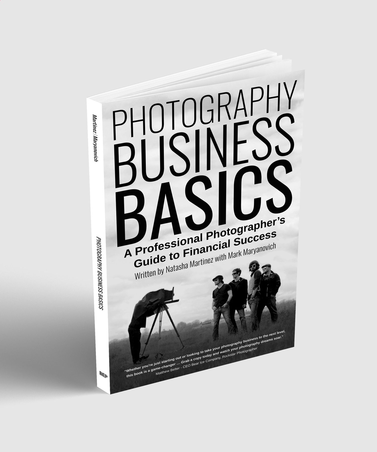 A white book cover titled Photography Business Basics shows a silhouette of a photographer with camera and tripod.