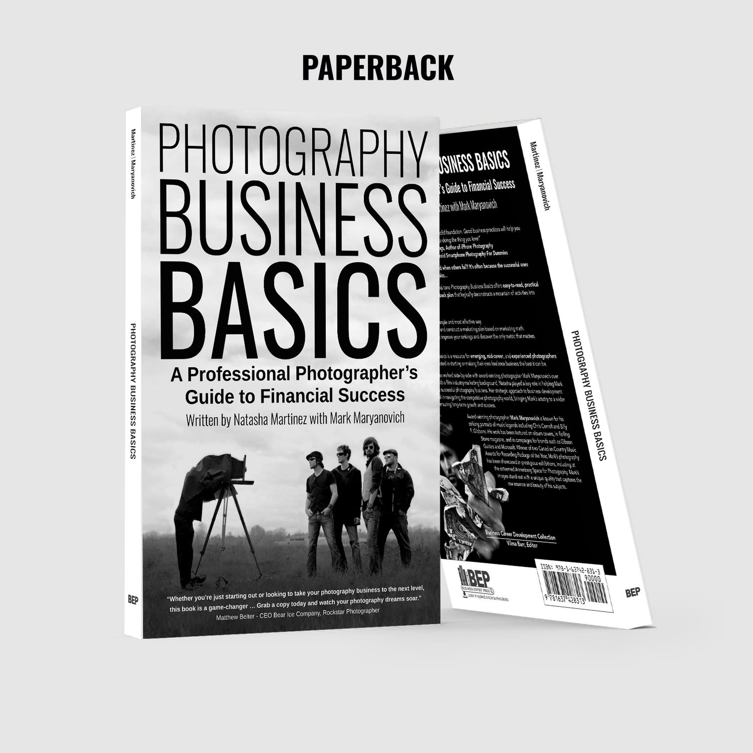 Black and white photography business book showing silhouette of photographer with camera and people in background.