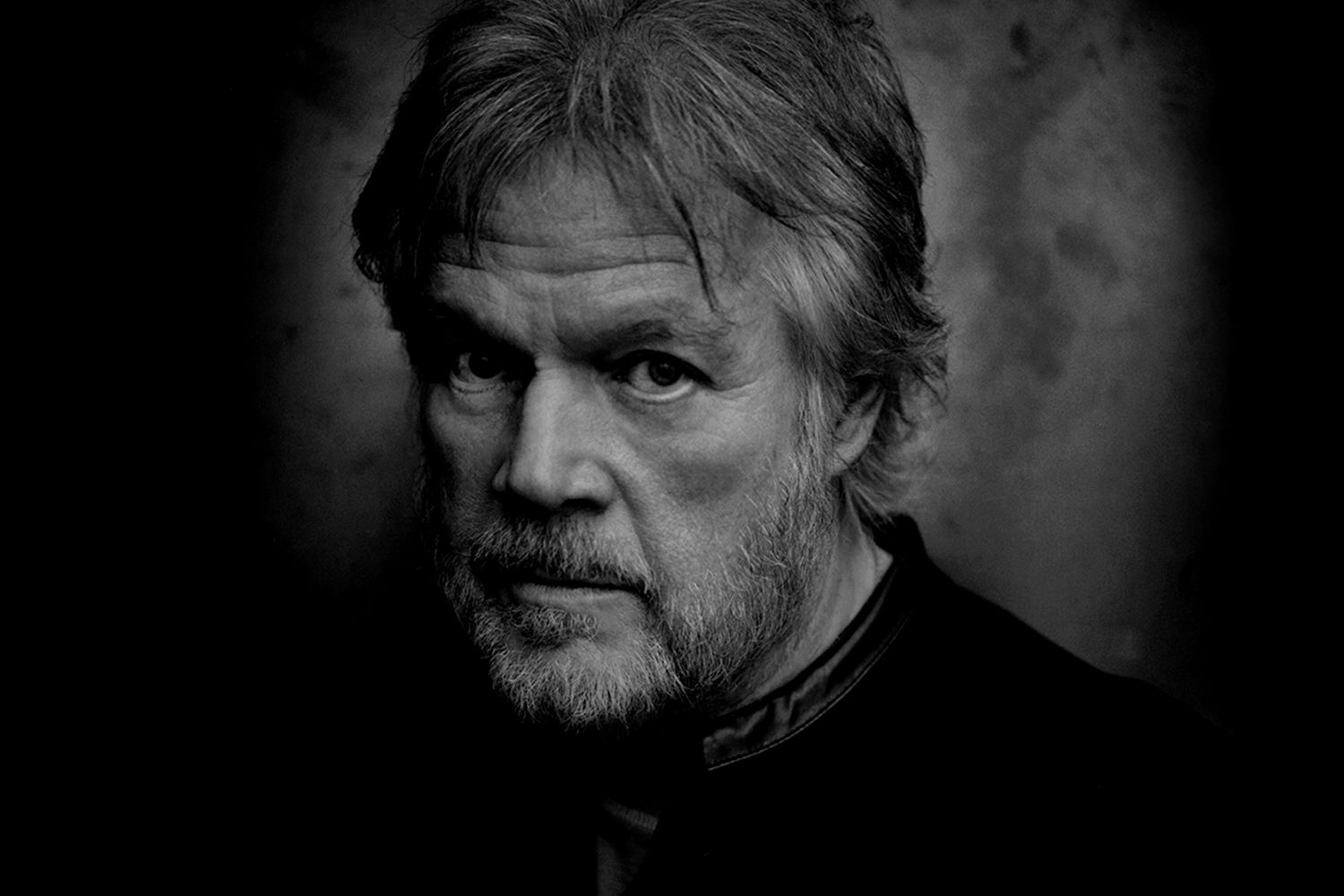 Randy Bachman black and white portrait closeup against dark background