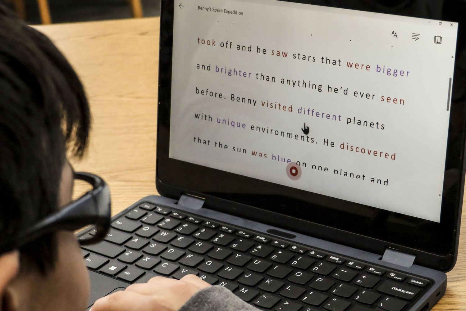 Microsoft Reading Coach  student sitting at desk  with computer screen close up