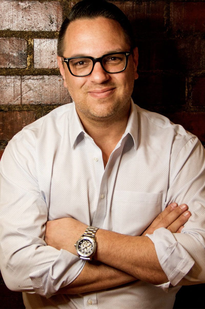 Company Headshot Jeff Bowler Los Angeles arms crossed in front of brick wall