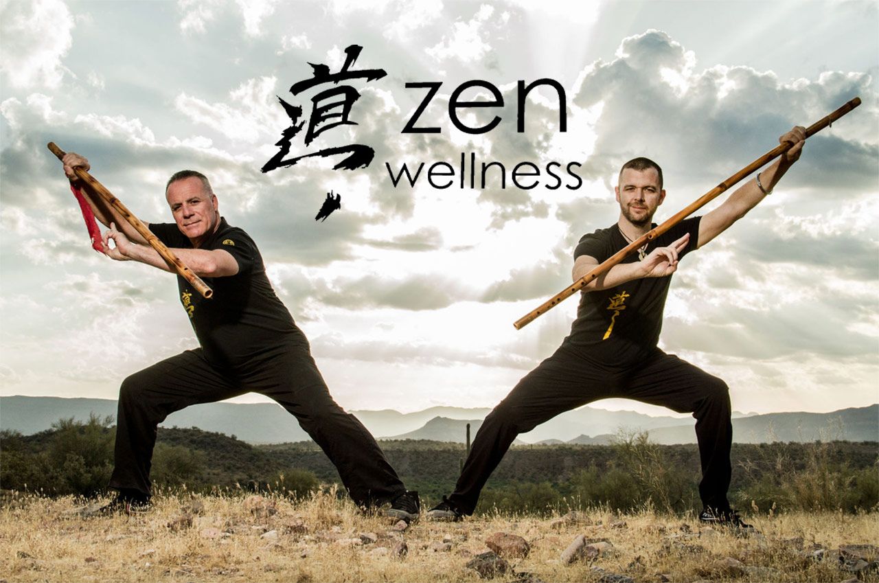 Branding Photo two Zen Wellness instructors with long wooden flutes standing in yoga poses on canyon with clouds and sun behind them