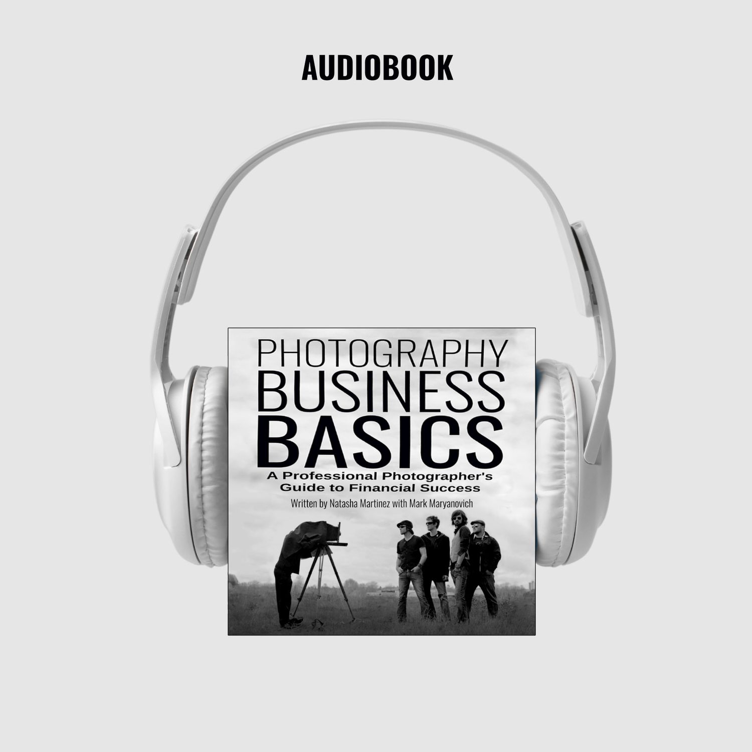 White headphones displaying audiobook titles about business and photography in black and white monochrome style.