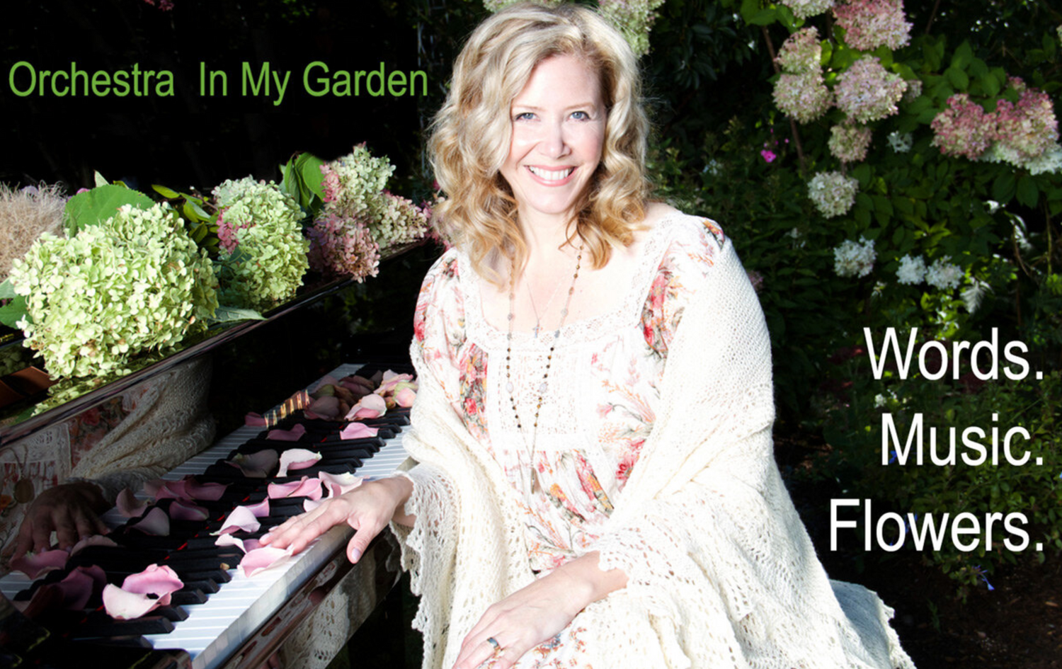 Branding promotional photo Author Linda Brooks sitting at grand piano covered in flowers and flower petals one hand on keys