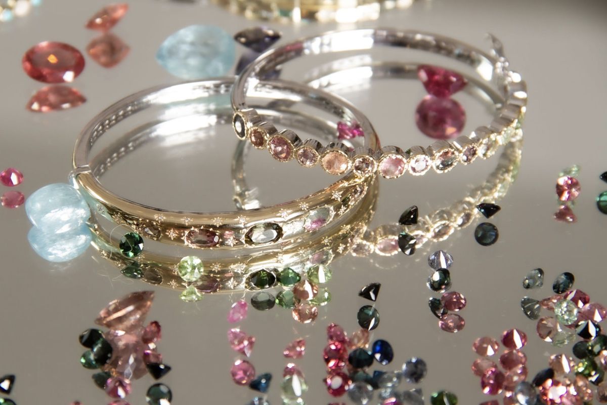 Brand Photography close up of products bracelets gem stones on silver tray