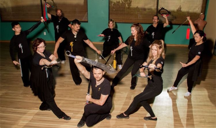 Group portrait of instructors in formation and various poses Zen Wellness Team