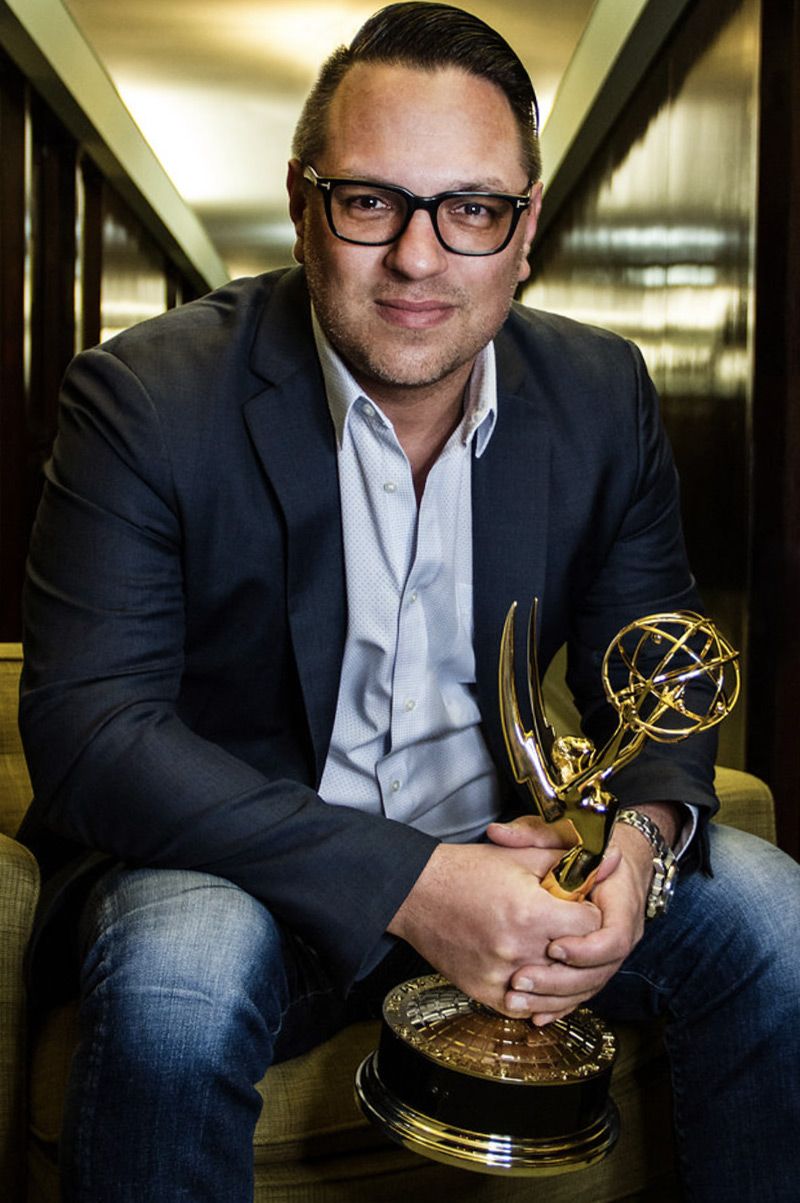 Company Portrait Jeff Bowler Los Angeles sitting while holding Emmy Award