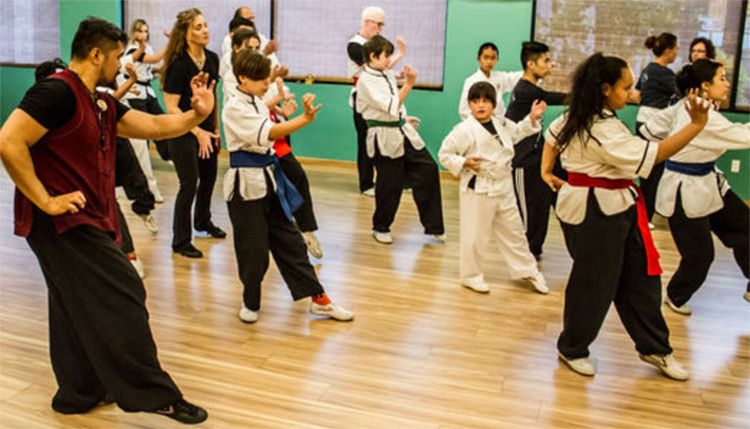 Instructors teaching young students in gi Zen Wellness