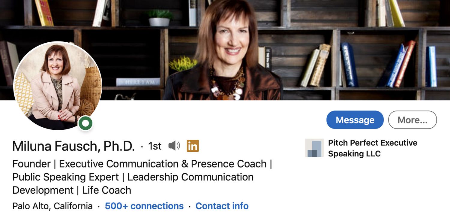 LinkedIn Profile Headshot with Banner Image Dr Miluna Fausch circle insert sitting with arms resting on crossed legs while smiling