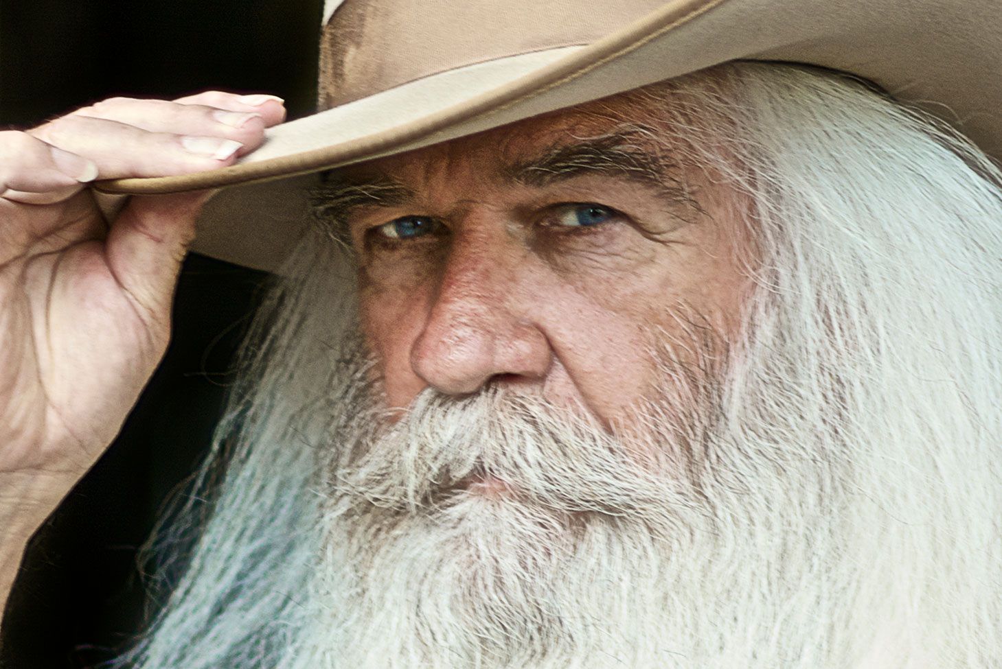 William Lee Golden Country Musician portrait closeup holding the brim of his cowboy hat