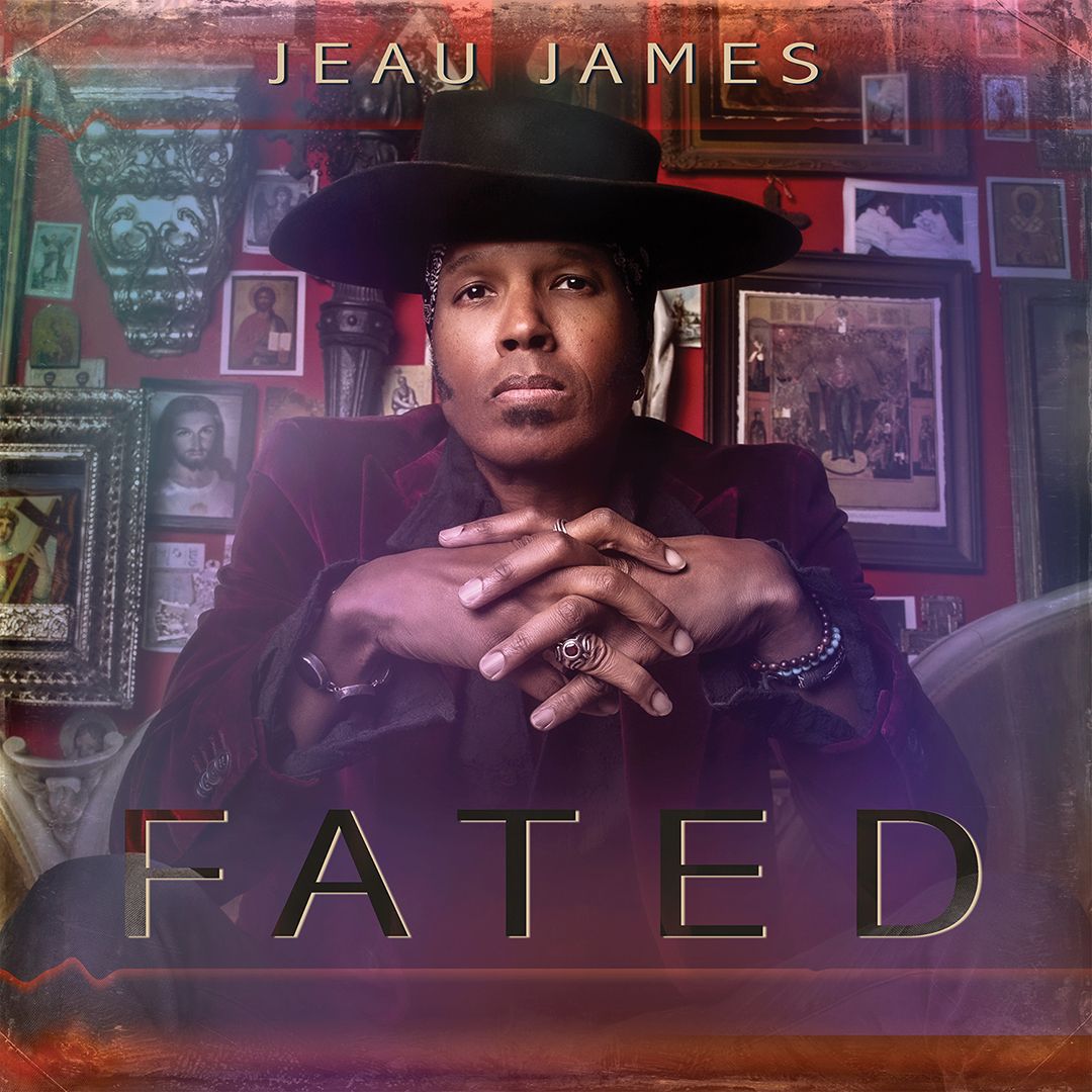 Album Cover Original Art Jeau James Title Fated sitting in front  of wall of framed pictures hand together wearing black cowboy hat