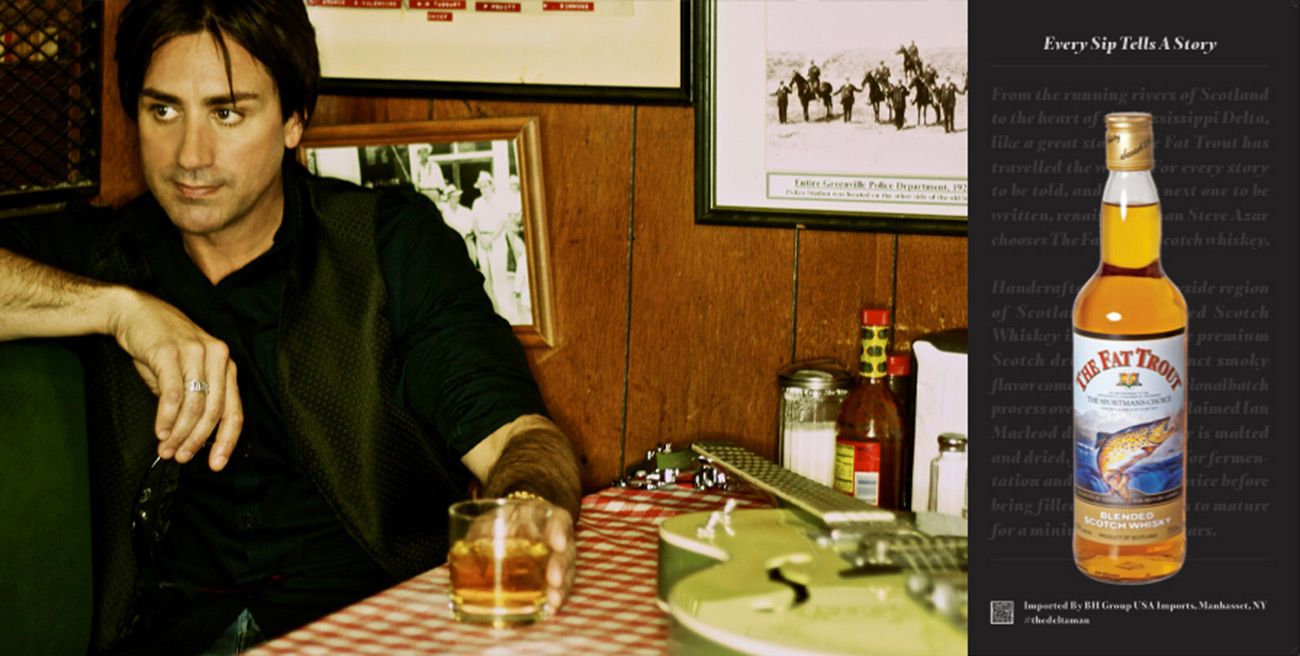 Branding Photo Steve Azar The Delta Man Fat Trout Whiskey sitting at restaurant booth with whisky glass