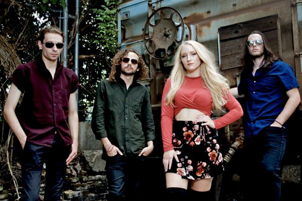 Nashville Tennesse band portrait Juliana Hale And Band of Roses standing against boxcar and trees