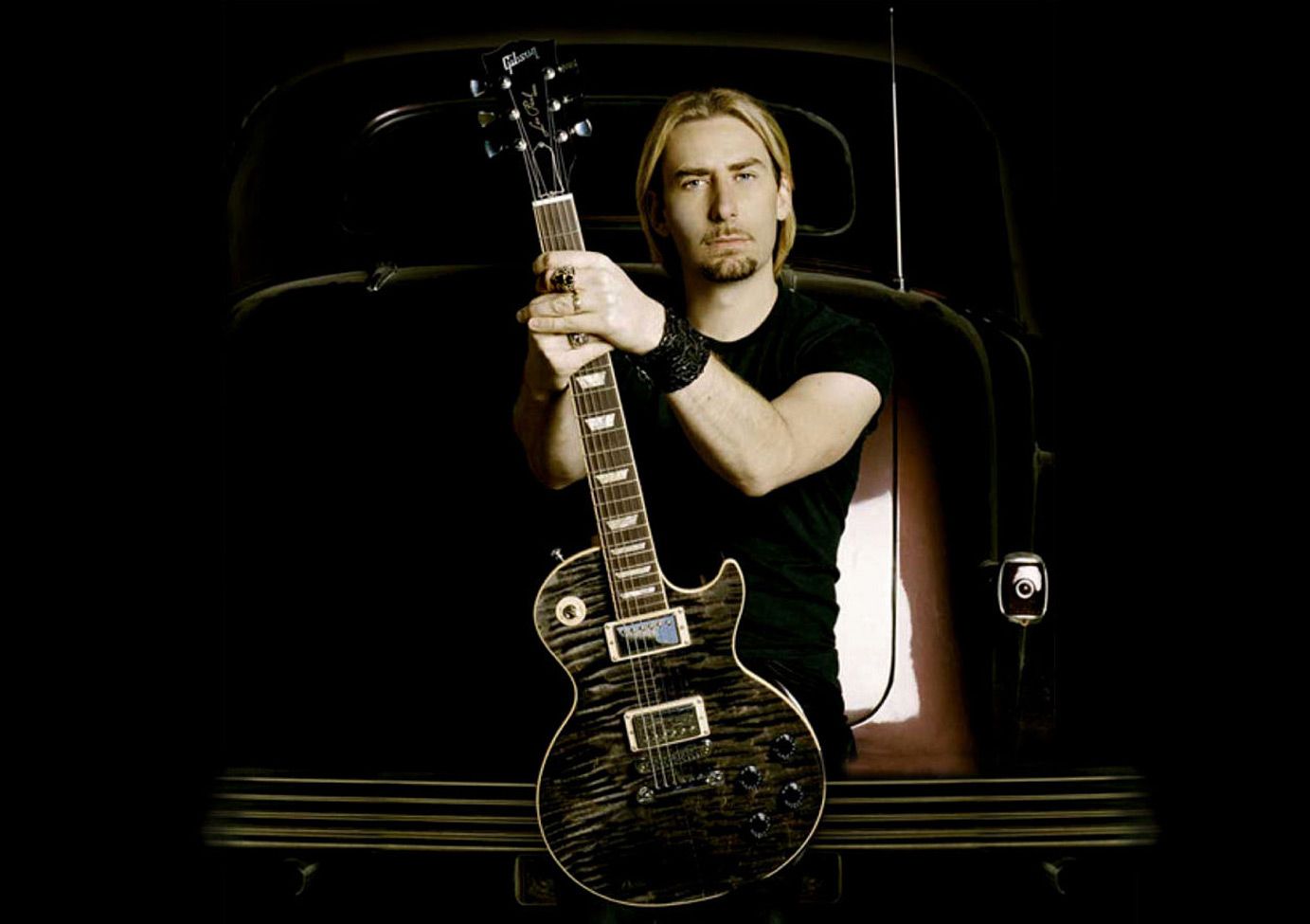Chad Kroeger Musician Portrait sitting on the back of burgundy vintage car holding his Signature Black Water Gibson Les Paul Guitar