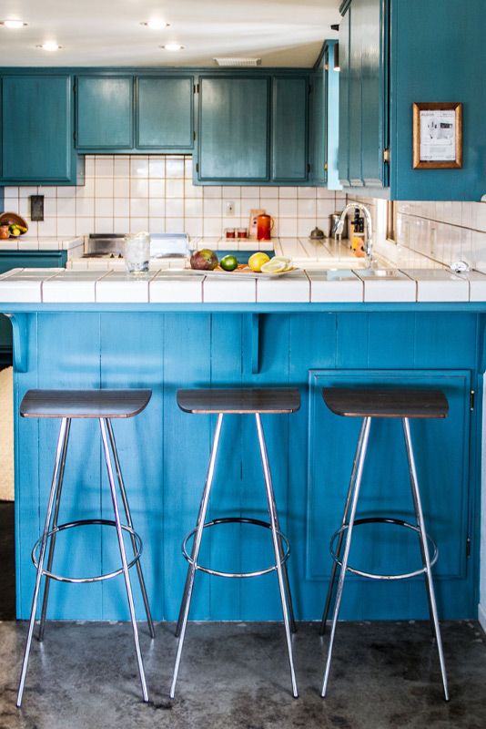 Place branding image Gatos Trail Ranch kitchen three stools in front of blue counter