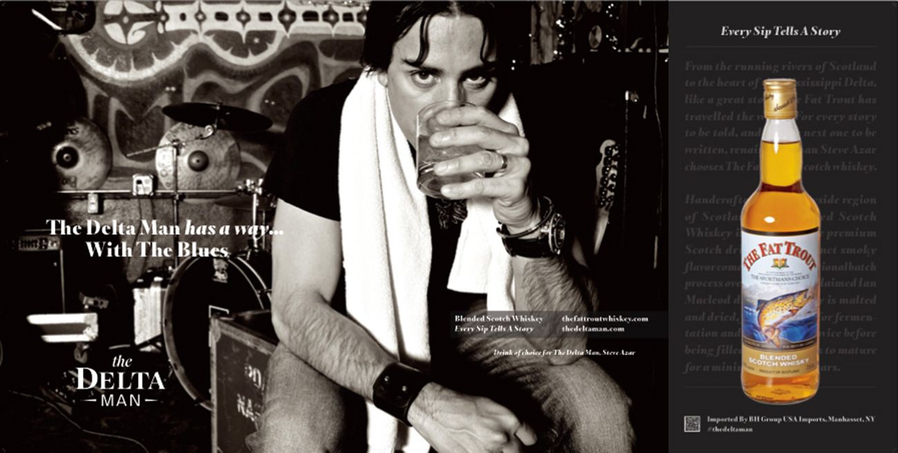 Fat Trout Whisky Branding Image Steve Azar The Delta Man towel around neck drinking whisky from glass