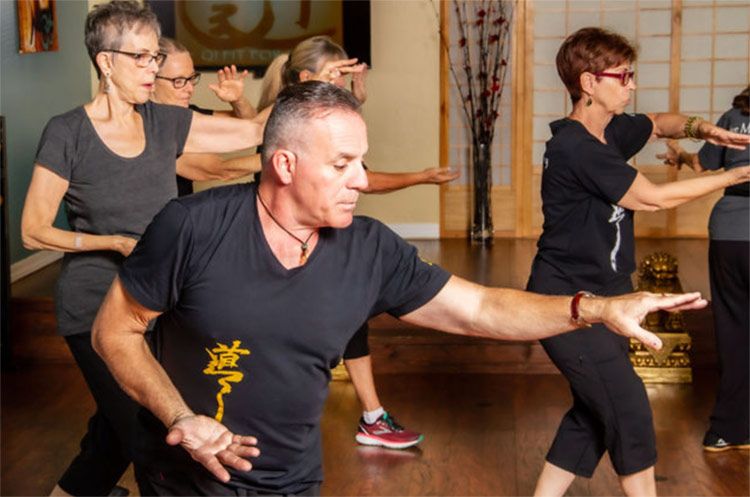 Instructor and Student portrait guiding through pose Zen Wellness