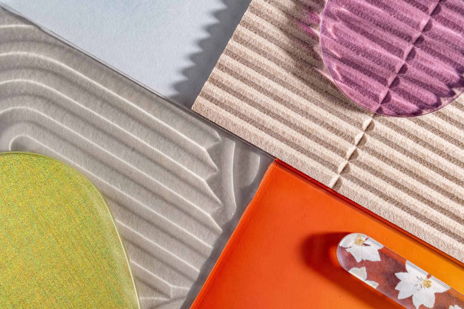 Colorful abstract pattern of pink, orange, and beige geometric shapes forming diagonal stripes.
