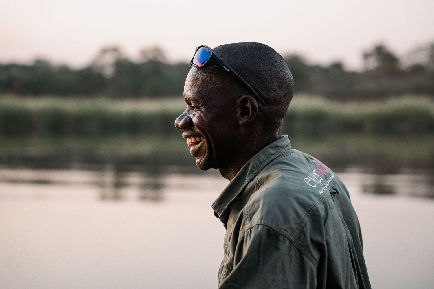 Professional lifestyle portraits captured by a lake in soft natural lighting during golden hour.