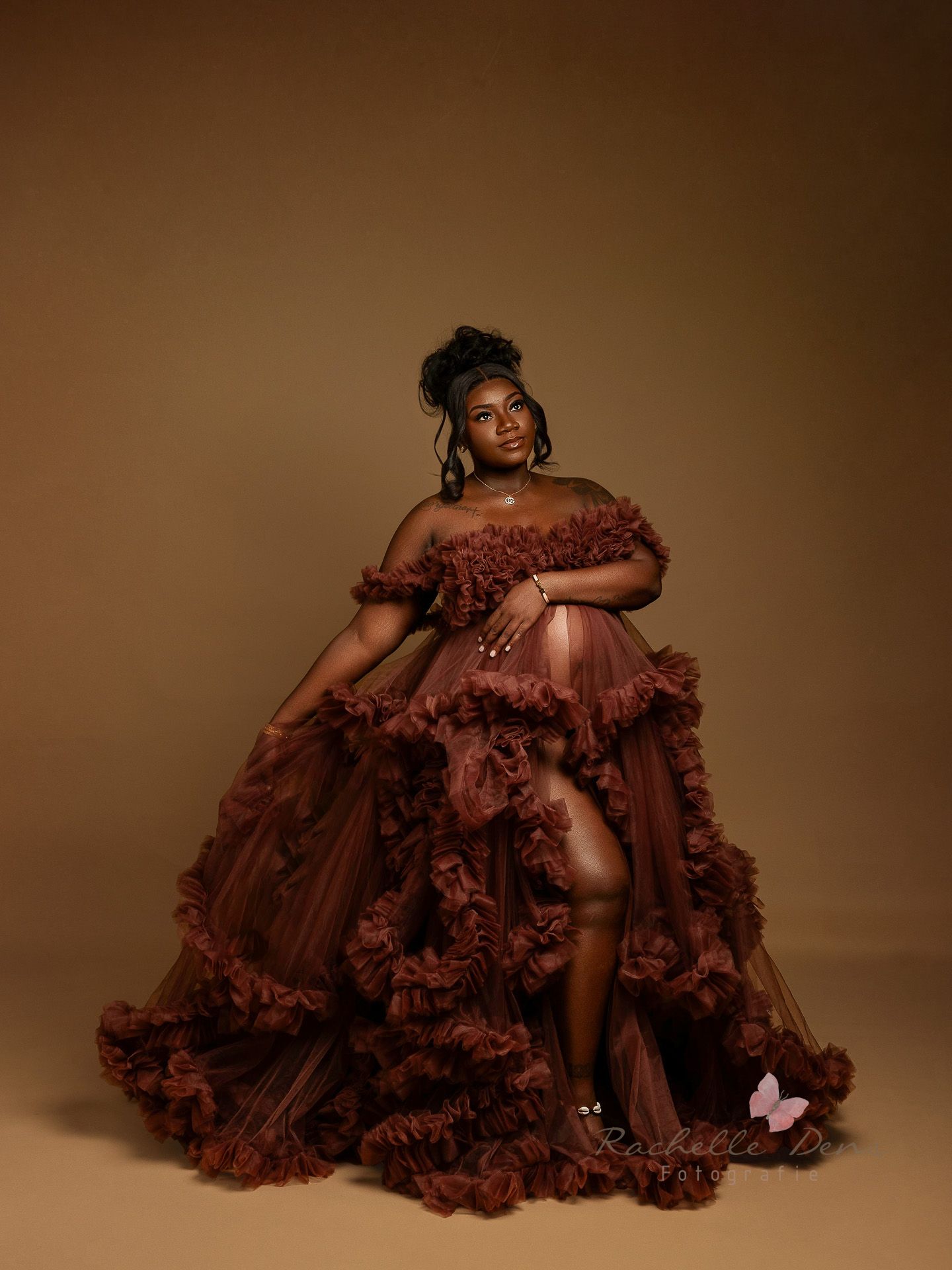 Dramatic fashion portrait series featuring a flowing burgundy tulle gown against a moody brown backdrop.