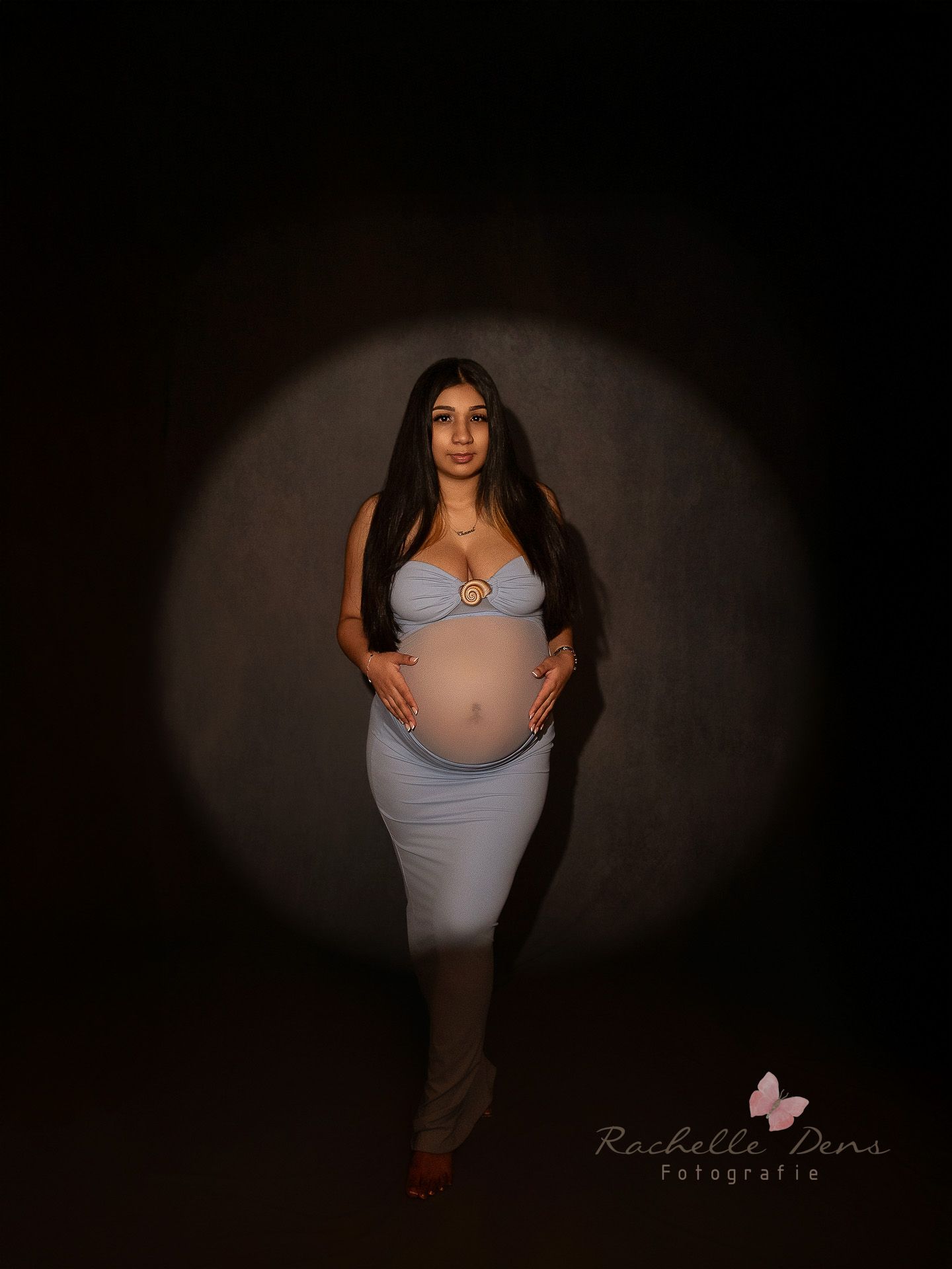 A series of maternity photos showing a woman in a light colored dress posing against a dark background.