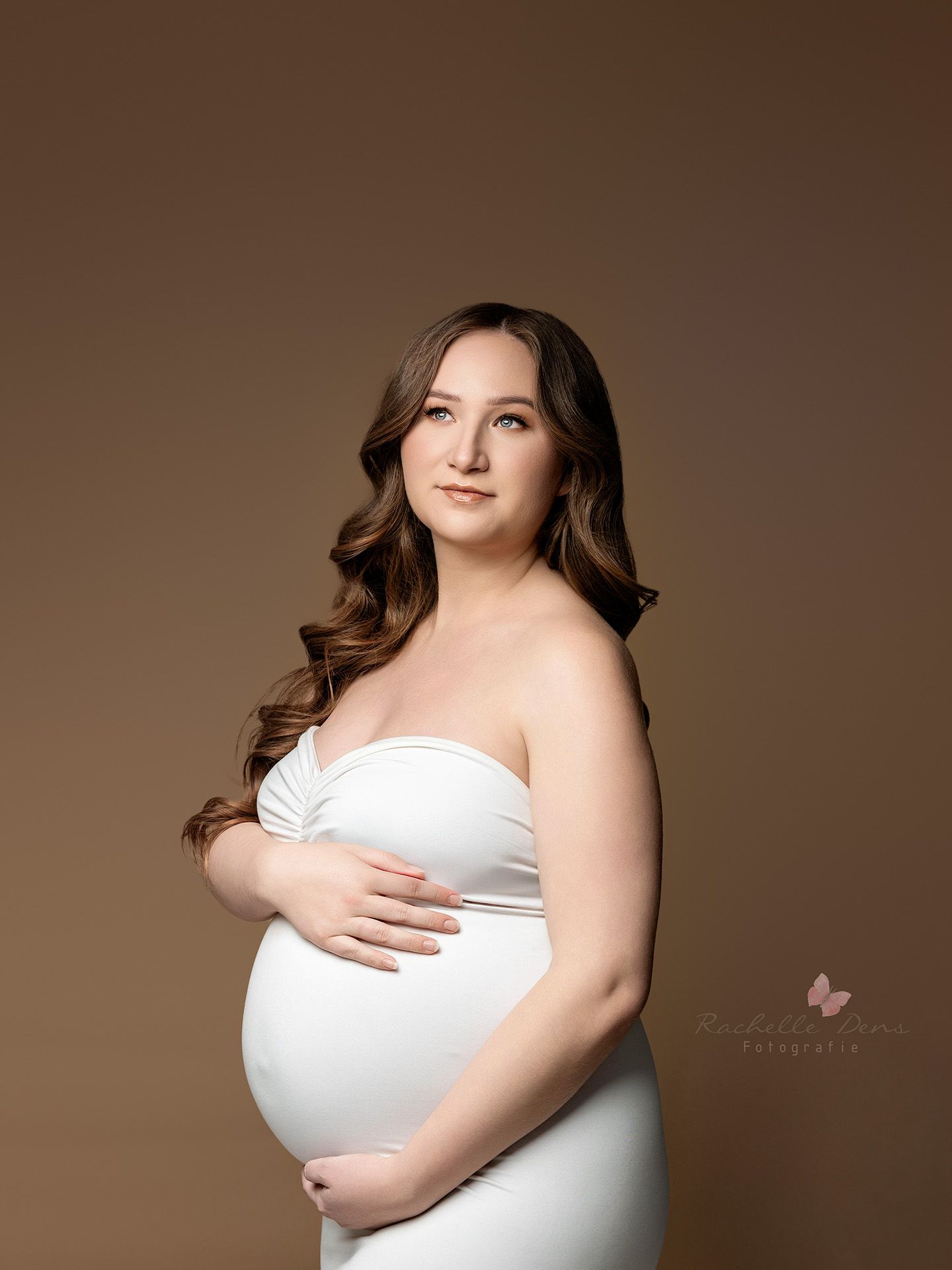 Maternity photography series showing four elegant poses in white dress against brown backdrop with soft lighting.