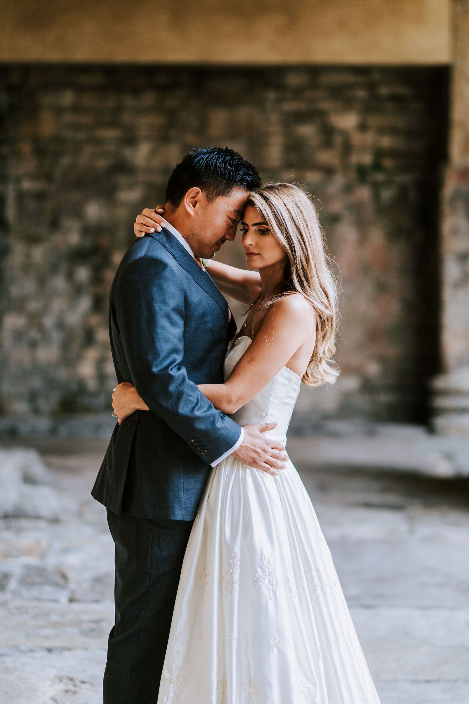 Intimate wedding portraits captured in a rustic indoor setting with natural light.