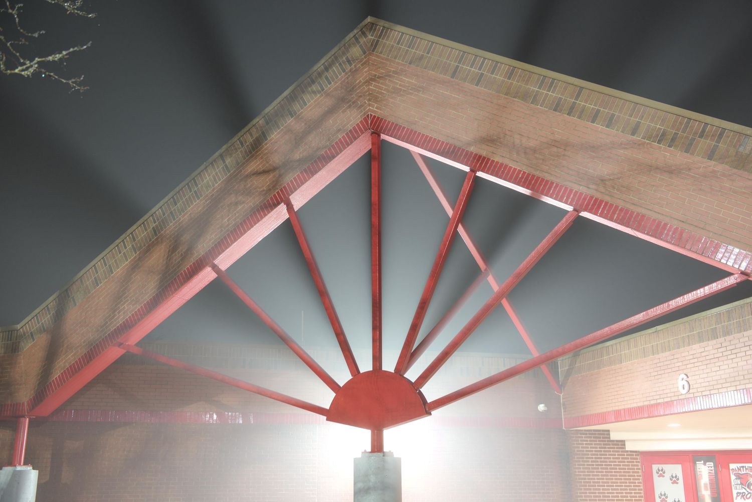Fog illuminates shafts of light from an architectural arch at Tri-County North School in Lewisburg, Ohio.