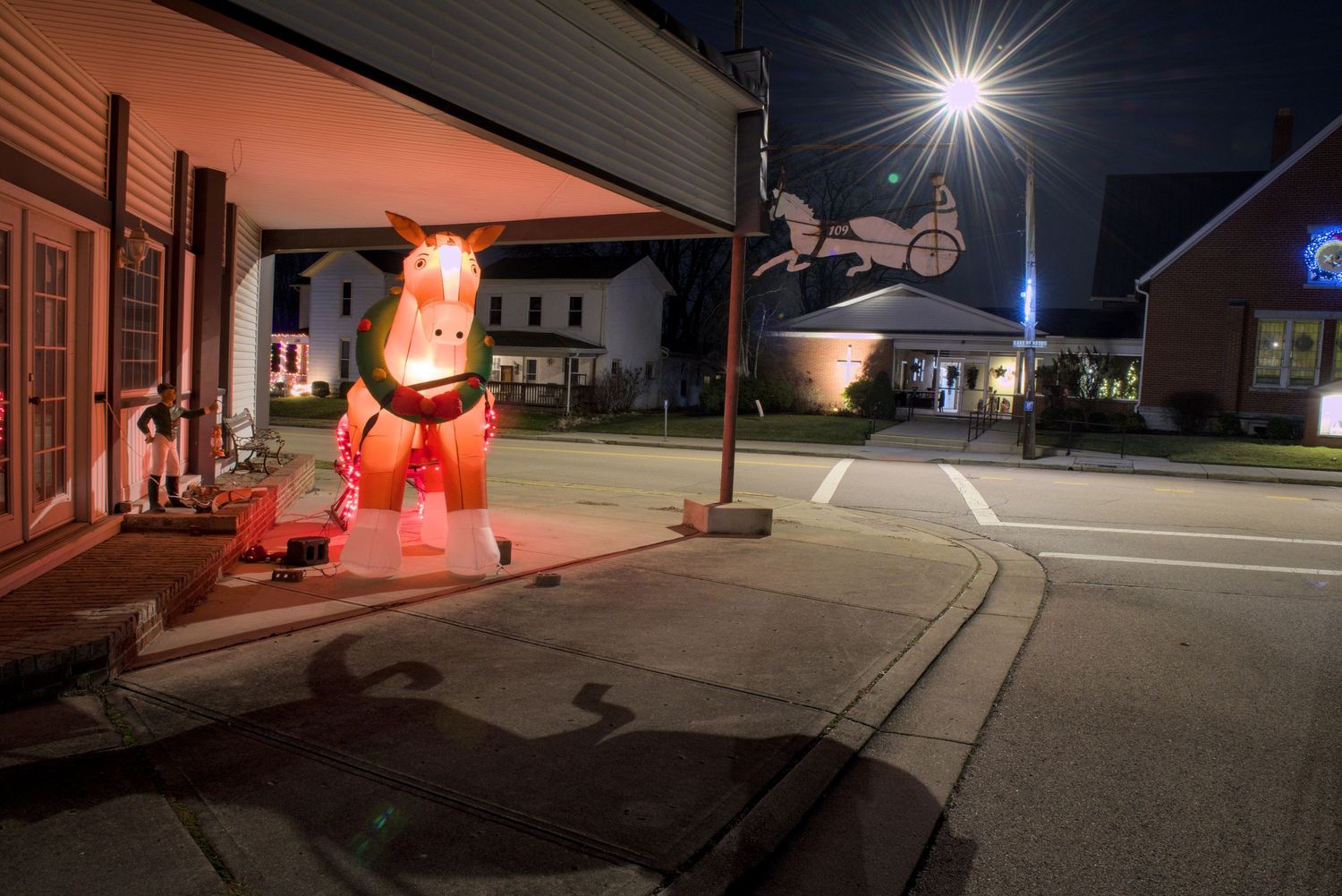 Holiday lights adorn decorations in front of a sulky store in Farmersville, Ohio.